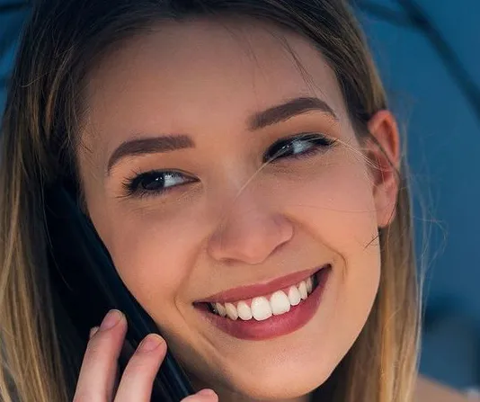 Woman talking on the phone smiling