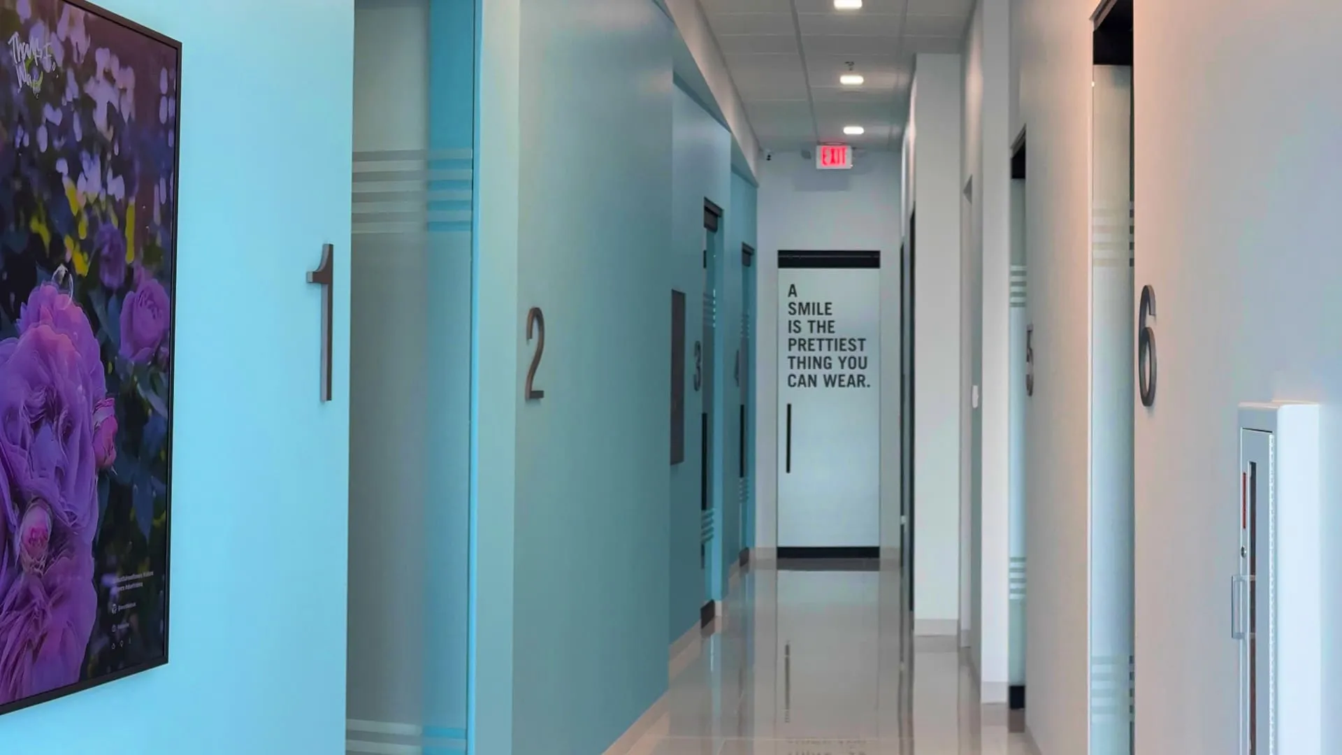 NuDentistry treatment room hallway with numbered operatories