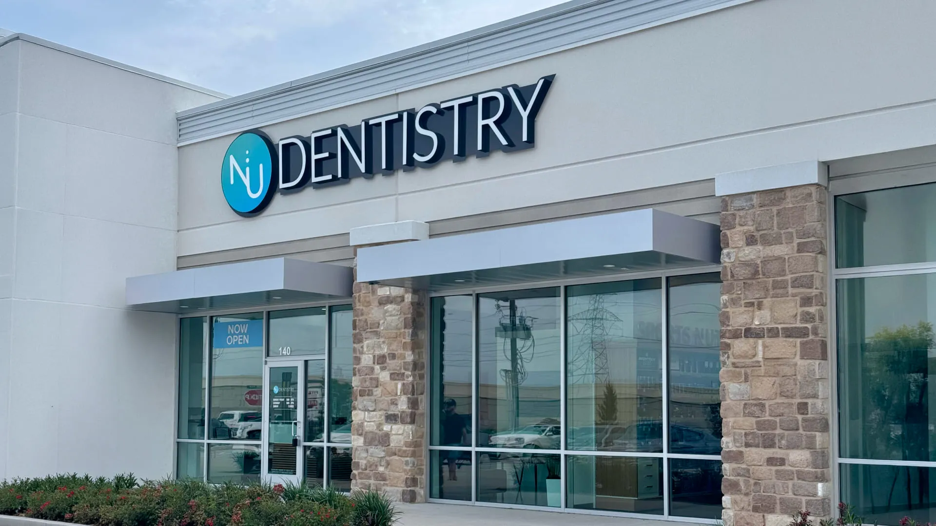 NuDentistry storefront with branded signage and stone column entry