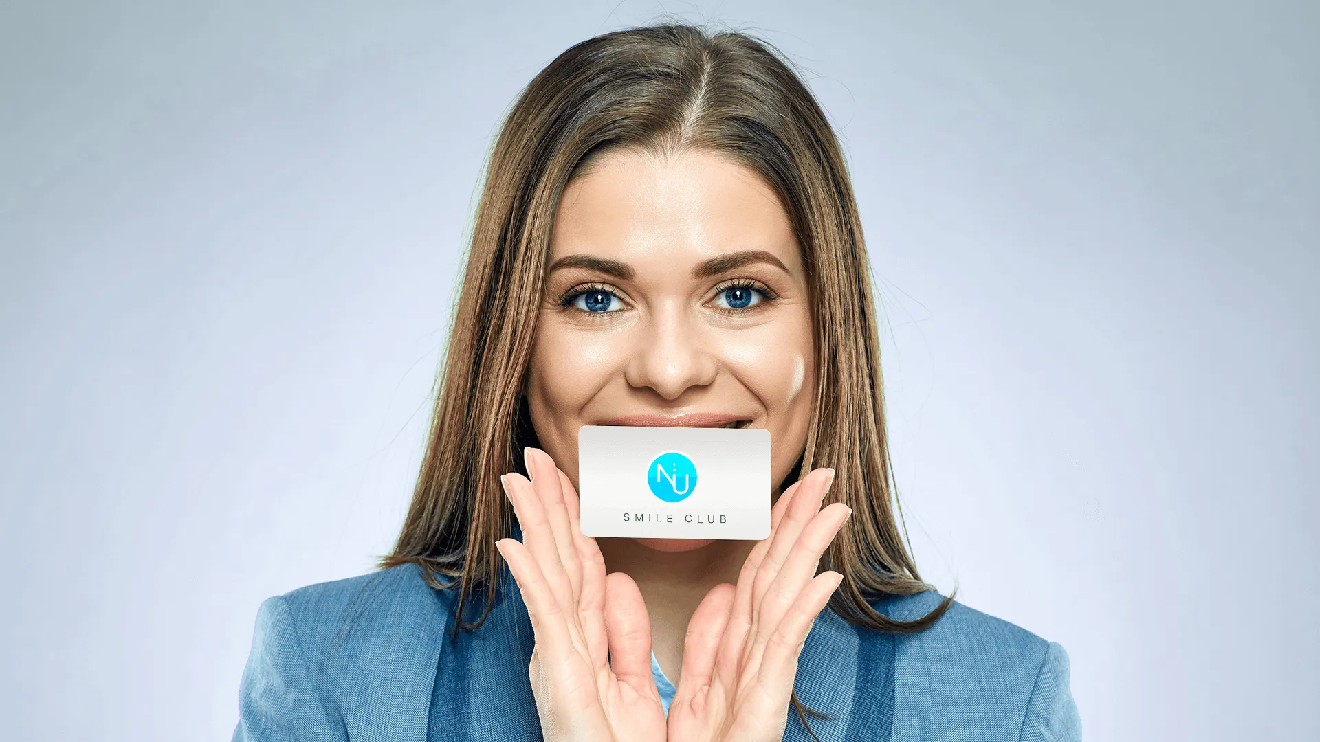 Woman holding Nu dentistry loyalty card